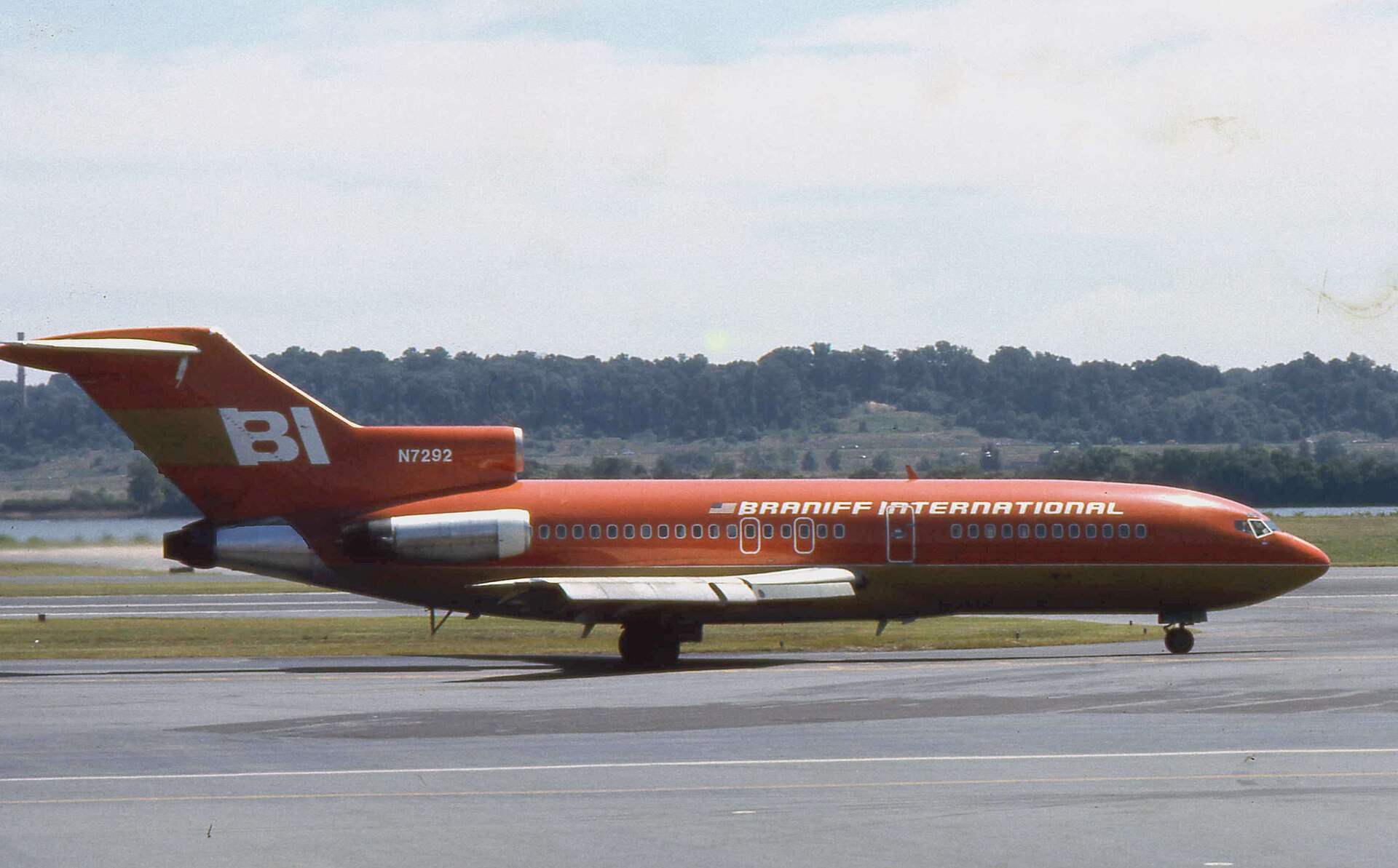 A Braniff Boeing 727 in Alexander Girard's solid-orange 'End of the Plain Plane' livery, Washington, 1975