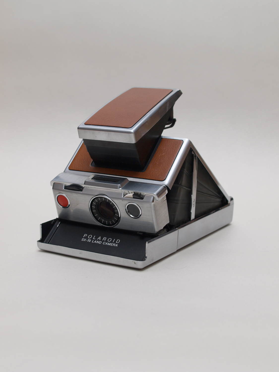 Polaroid SX-70 folding instant camera, silver and tan, shown open
