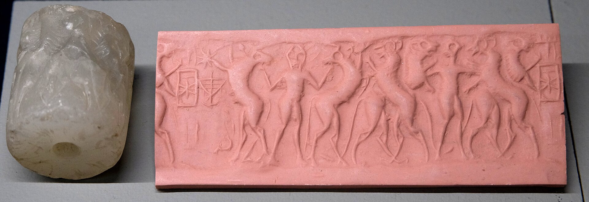 Early Dynastic cylinder seal impression inscribed Ama-Ushumgal, a name of Dumuzi, with a bull-man attacking quadrupeds