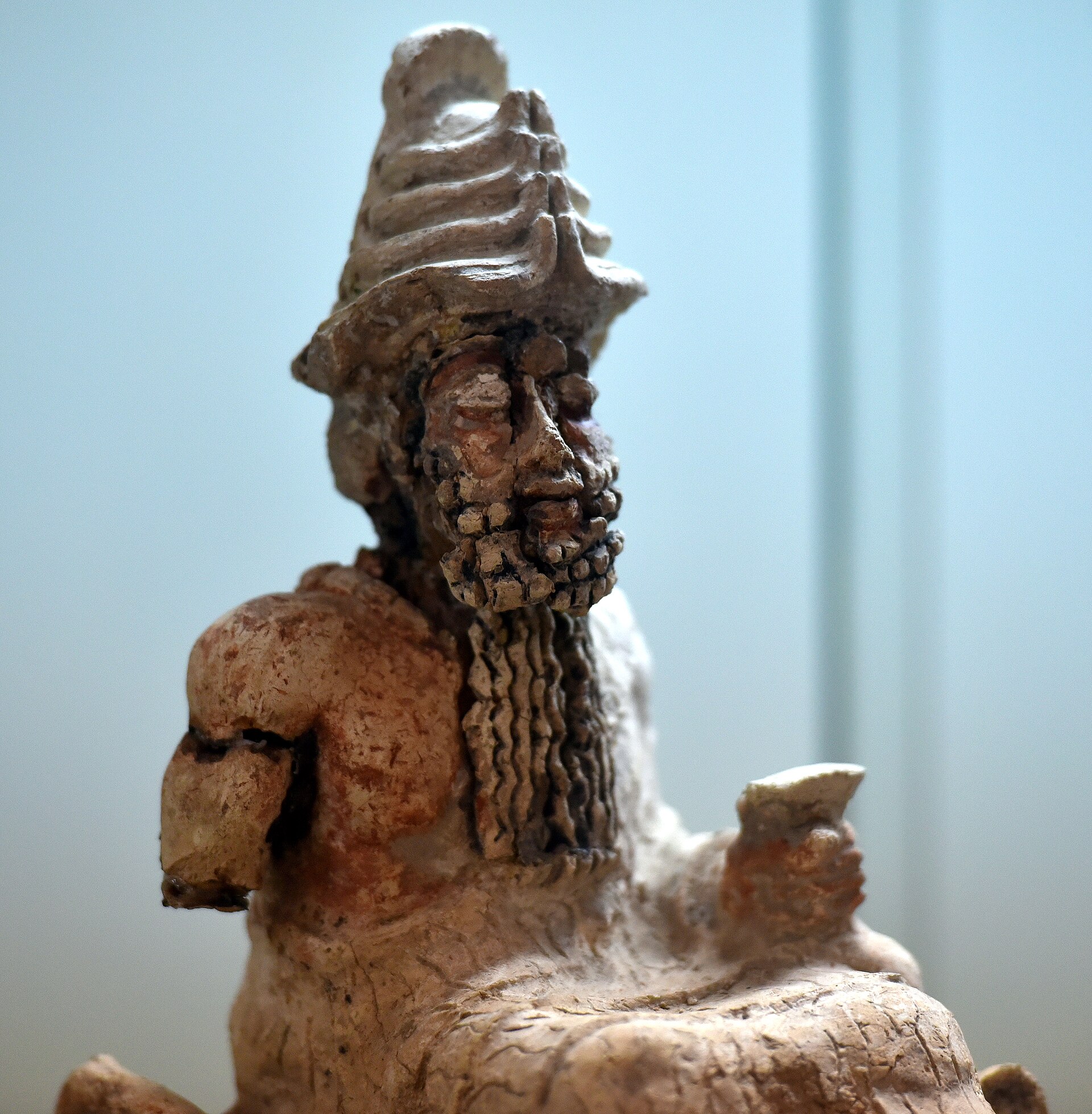 Old Babylonian statue of the god Ea (Enki) enthroned holding a cup, flanked by fish-men, from Nasiriyah, Iraq, 2004-1595 BCE