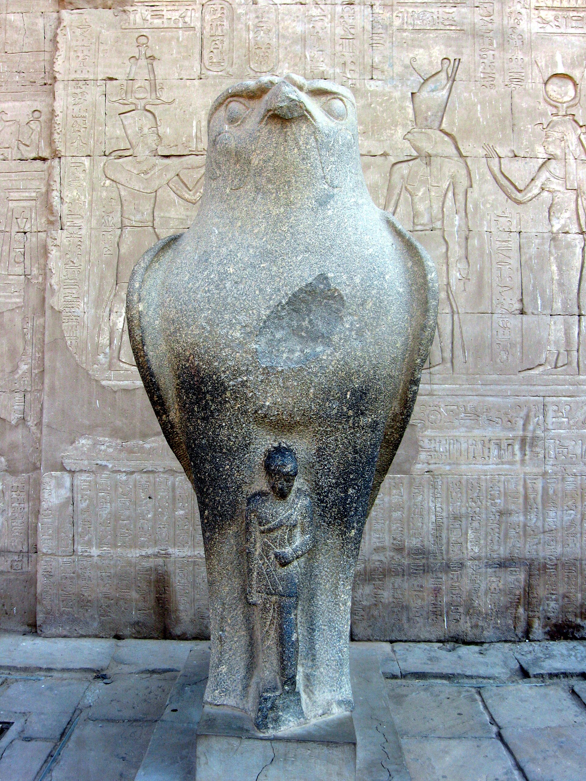 Black granite statue of the falcon god Horus wearing the double crown of Upper and Lower Egypt, at the entrance to the Temple of Edfu
