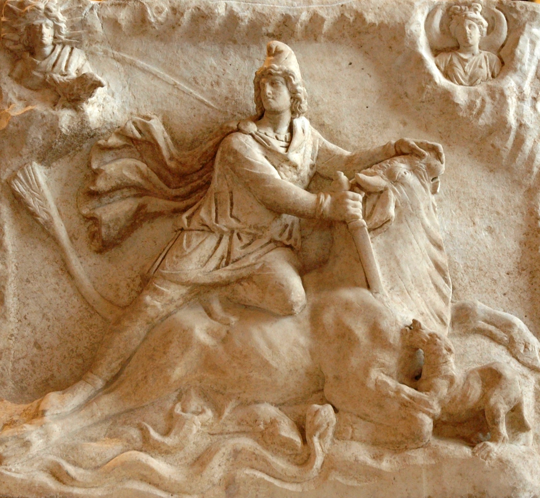 Roman marble relief of Mithras kneeling on a bull and driving a dagger into its neck, flanked by torchbearers, with a dog, serpent and scorpion at the wound