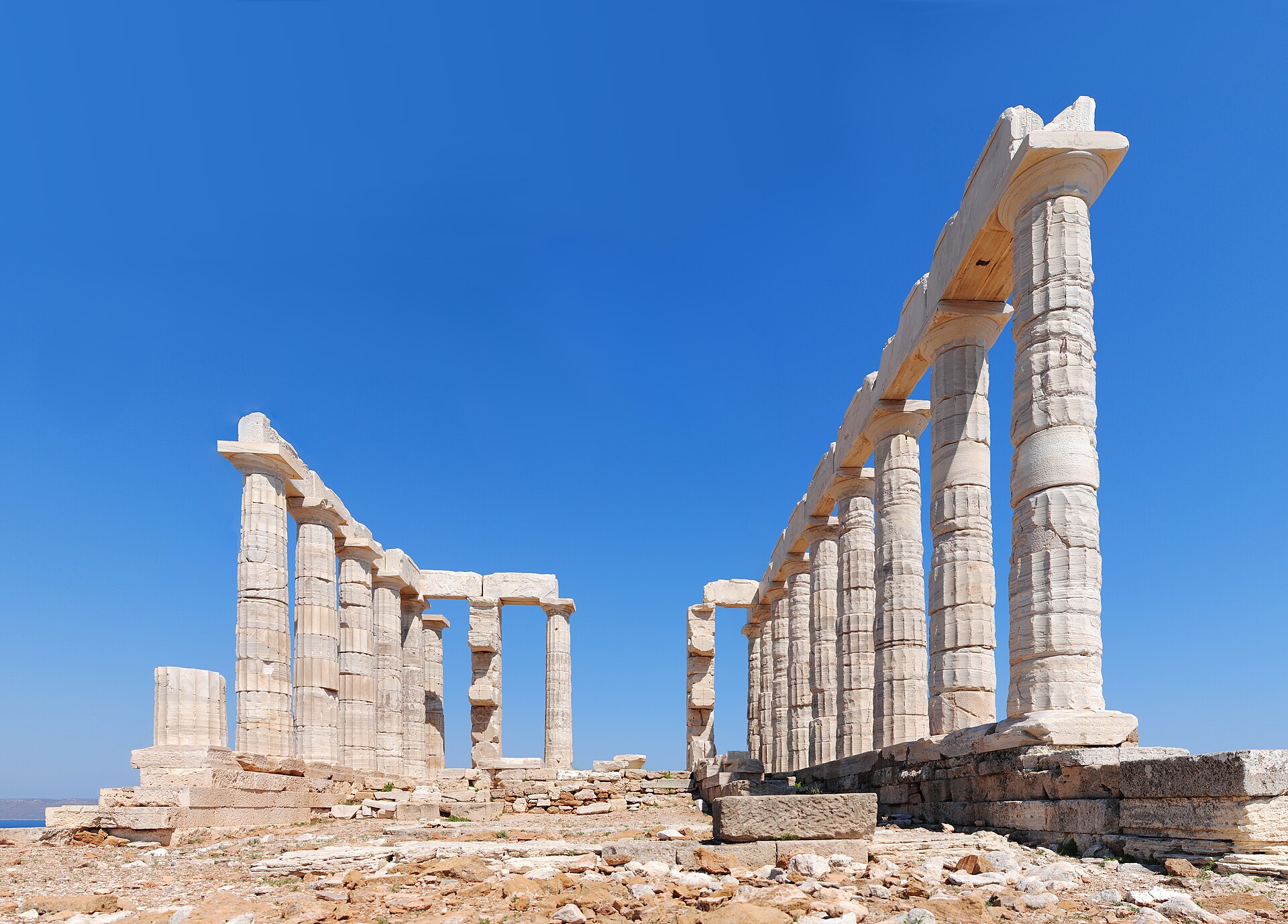 The marble Doric columns of the Temple of Poseidon at Cape Sounion, built 444–440 BCE, standing on the cliff above the Aegean Sea
