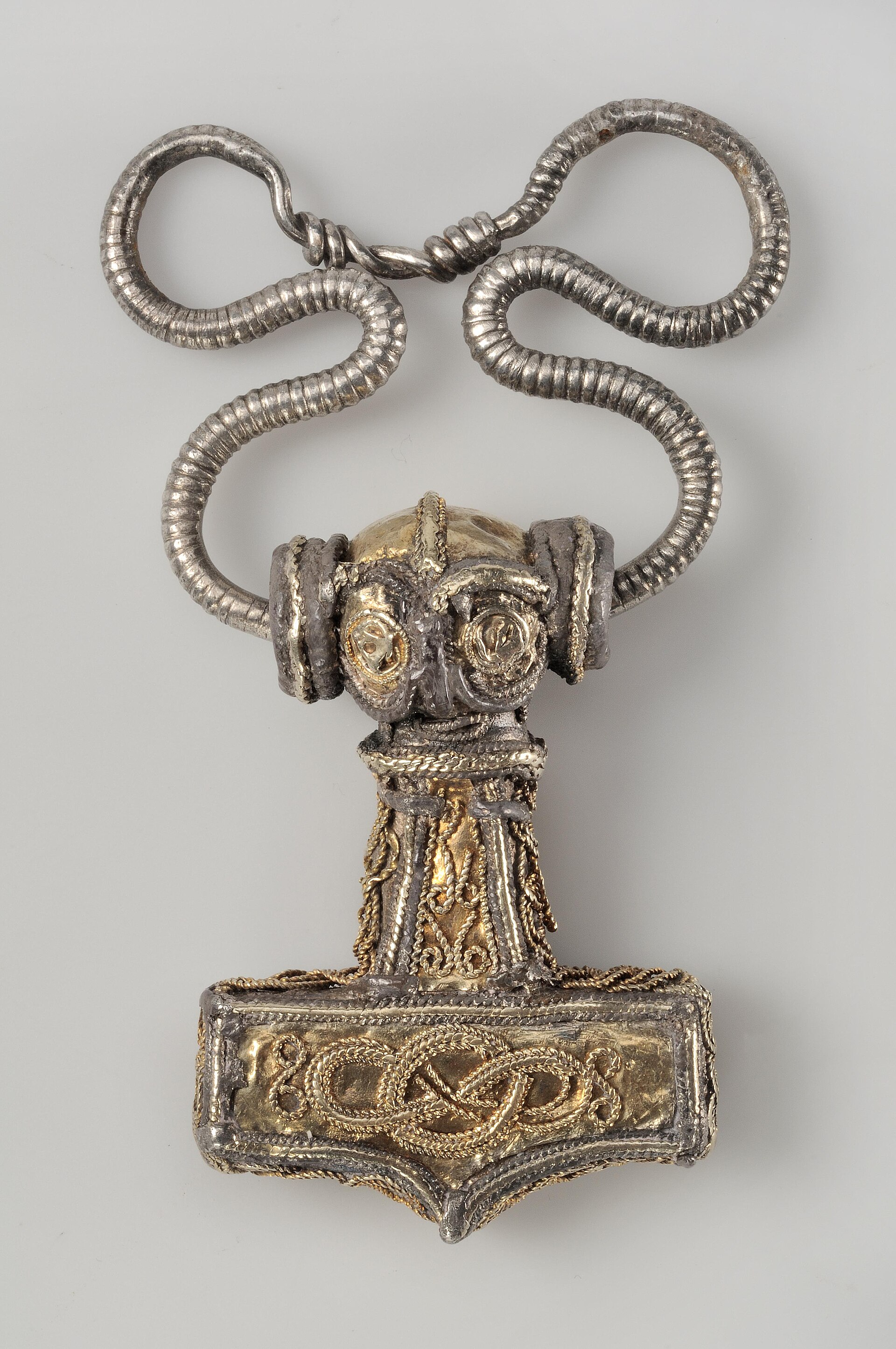 A Viking-Age Thor's-hammer (Mjölnir) pendant in gold and silver filigree, the commonest pagan amulet of the age, Swedish History Museum