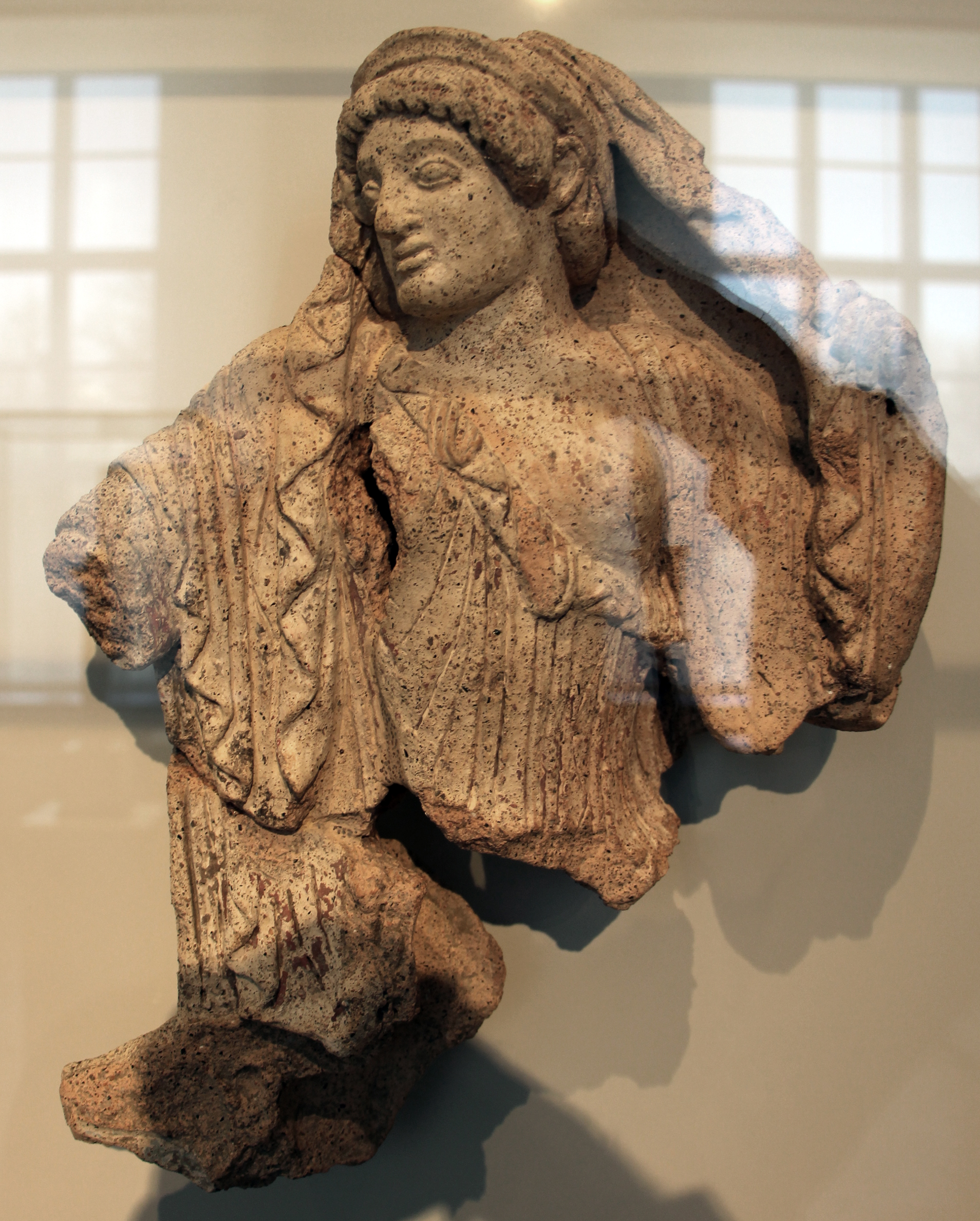 Etruscan terracotta acroterion of a goddess unveiling, excavated at Campo della Fiera (Fanum Voltumnae), Orvieto, c. 470 BC
