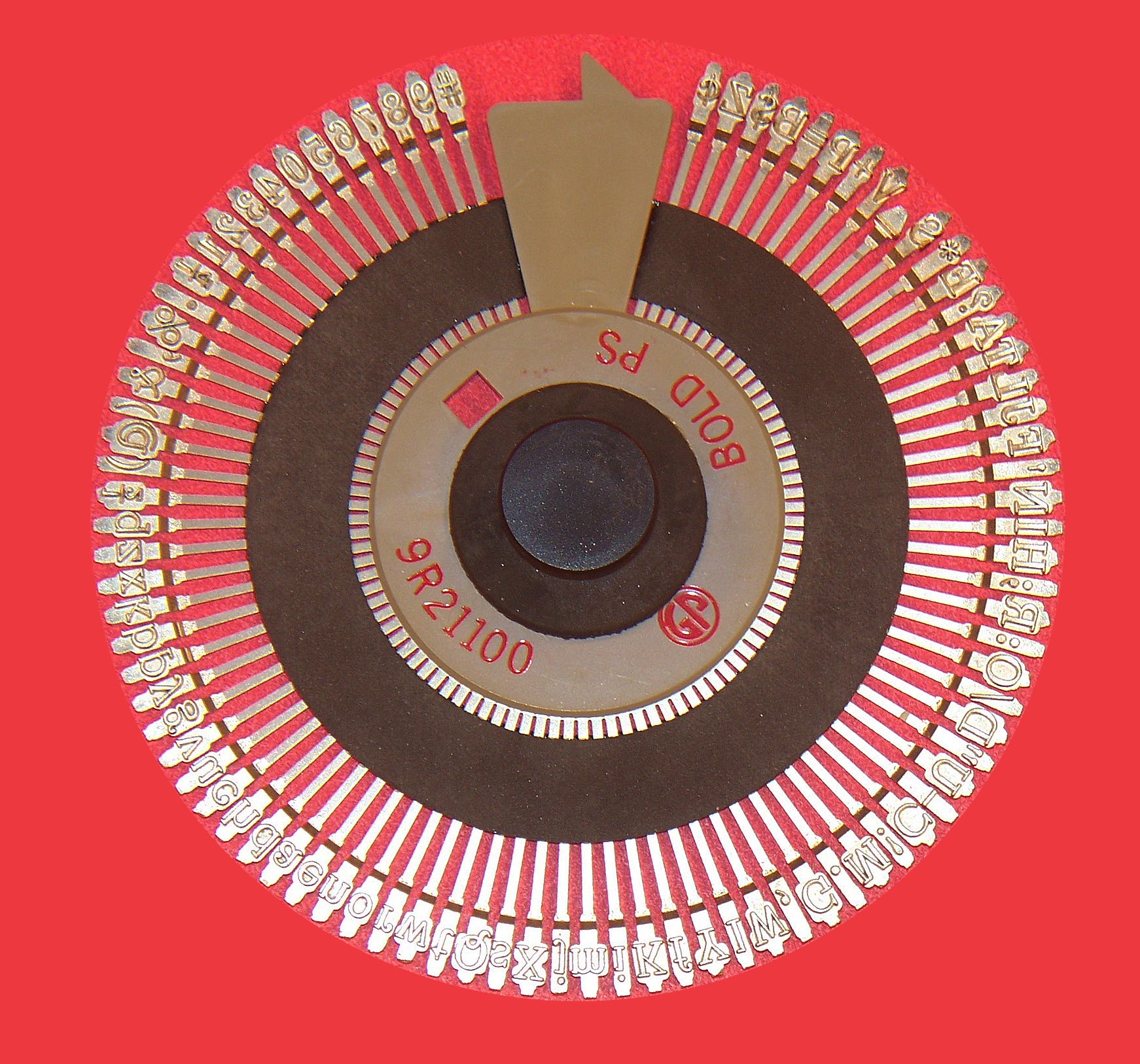 Close-up of a daisy wheel print element showing the spokes with character glyphs