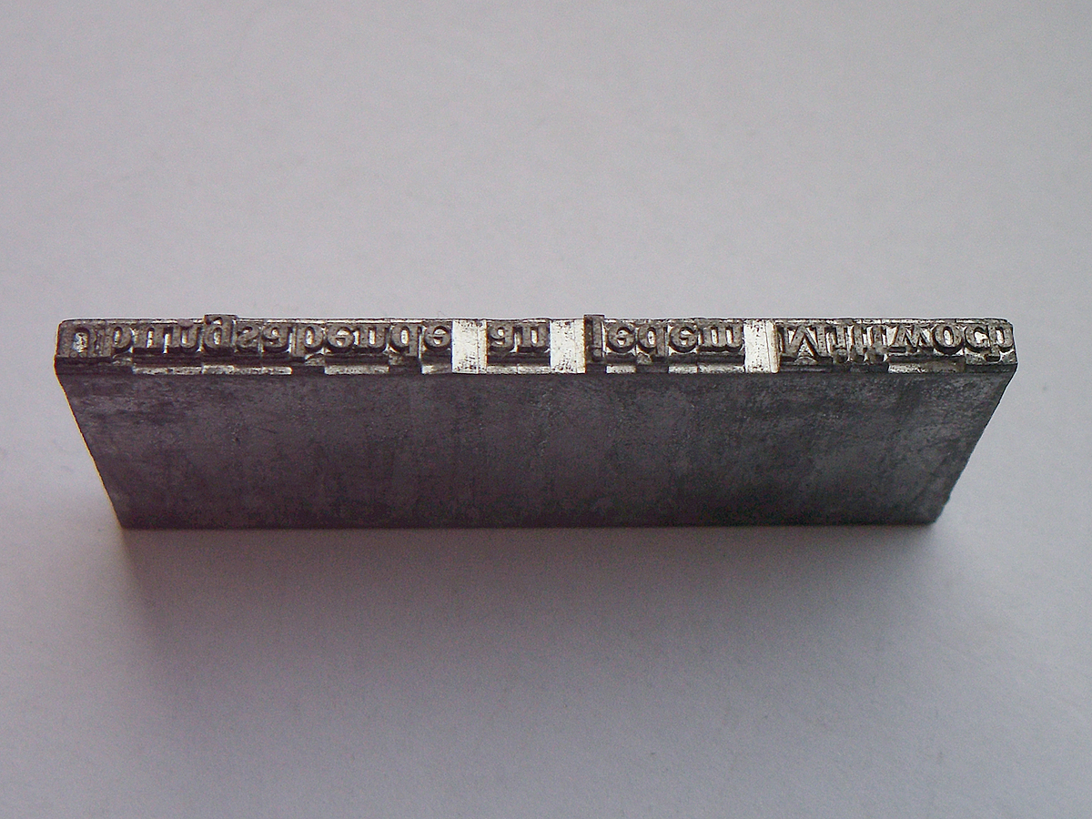 A cast Linotype type slug, a single line of metal type produced by the machine
