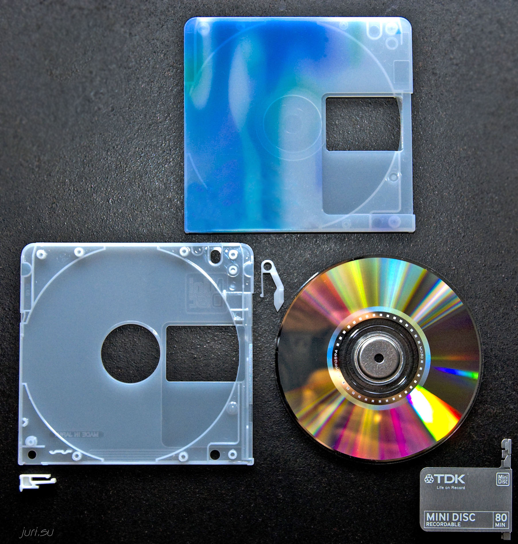 MiniDisc disassembled, showing the magneto-optical disc removed from its plastic shell
