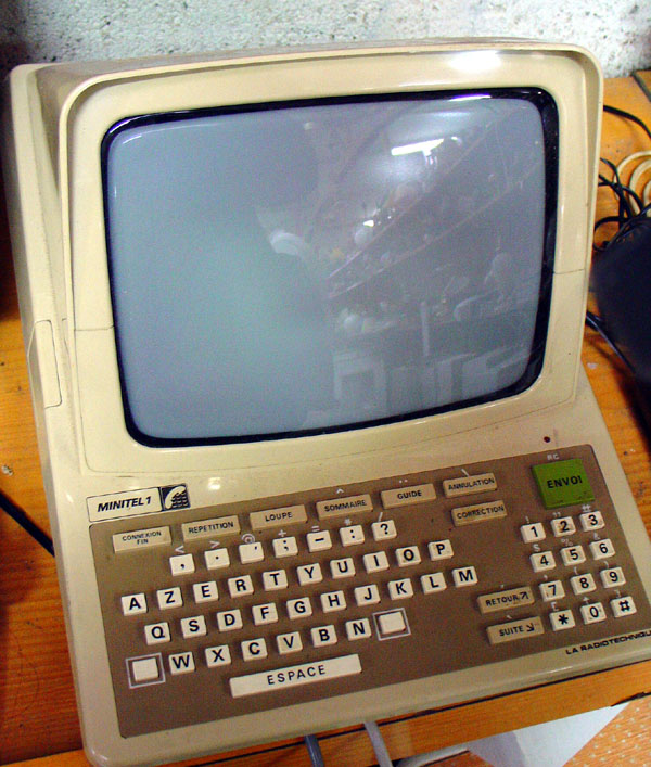 A French Minitel 1 terminal (1982): a beige unit with a small CRT screen, keyboard and built-in modem for the Teletel network.