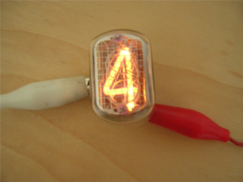 An IN-12A Nixie tube lit for the first time, glowing the numeral 4