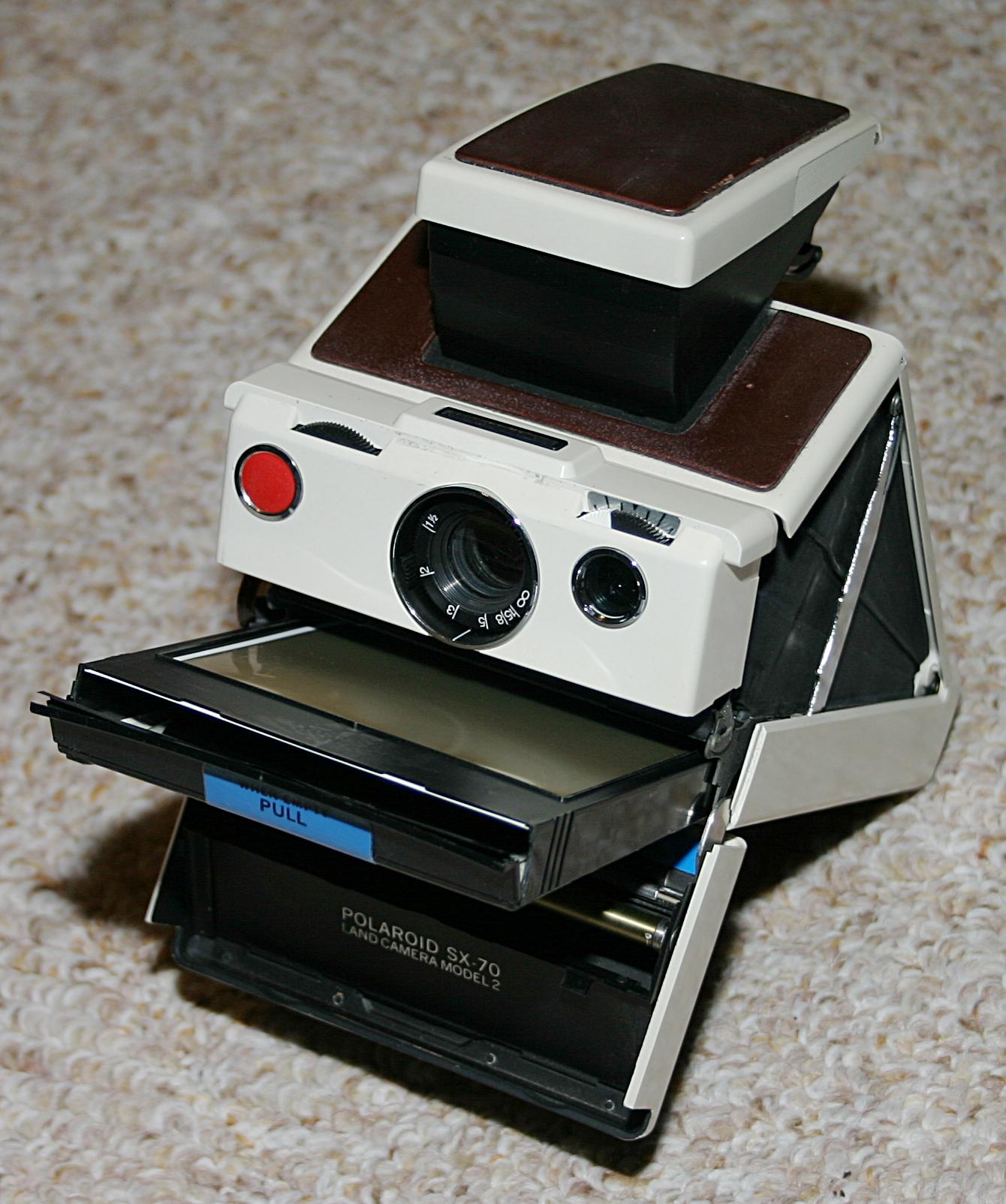 A folded Polaroid SX-70 Land Camera, the instant-film camera that developed prints in the open air.