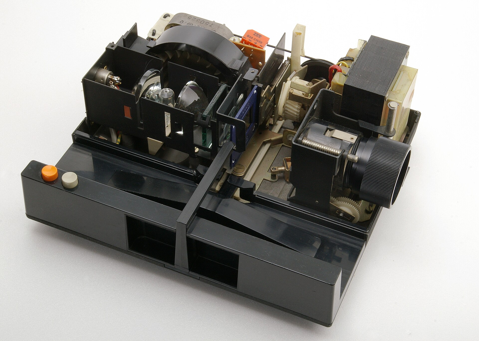 A typical 35mm slide projector opened to show its internal mechanism