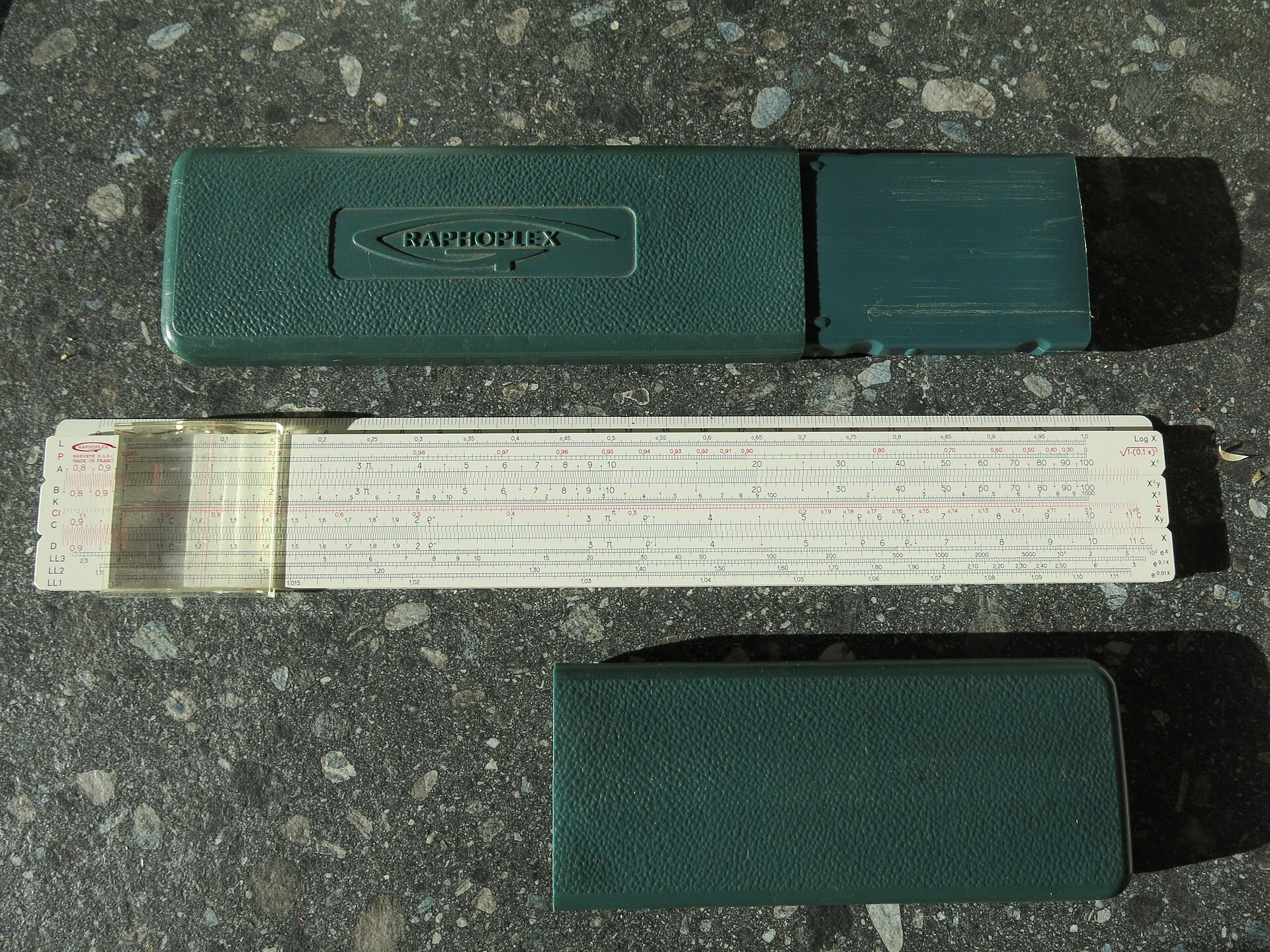 A Graphoplex slide rule, showing its sliding logarithmic scales