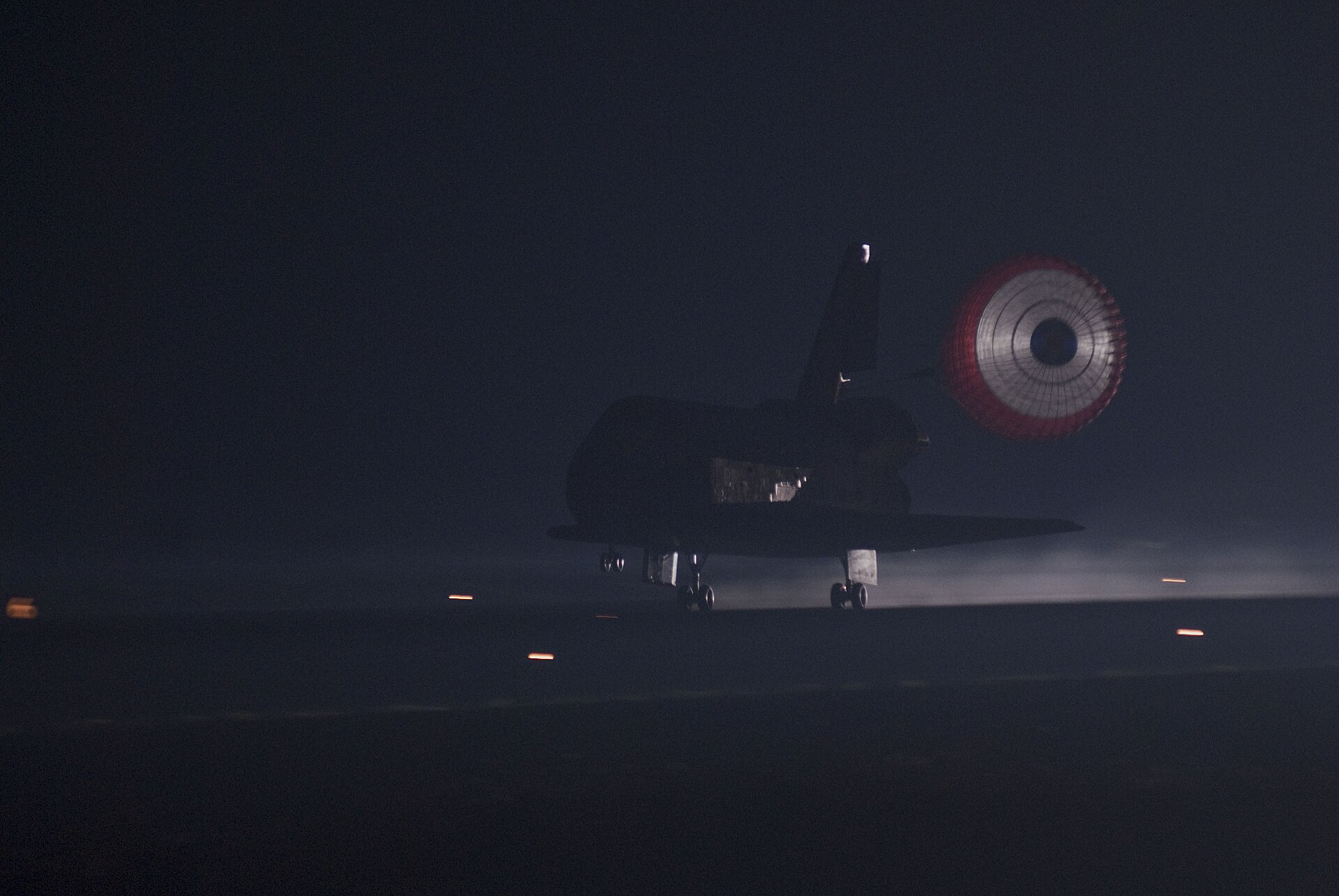 Space Shuttle Atlantis with drag chute deployed on its final landing, STS-135