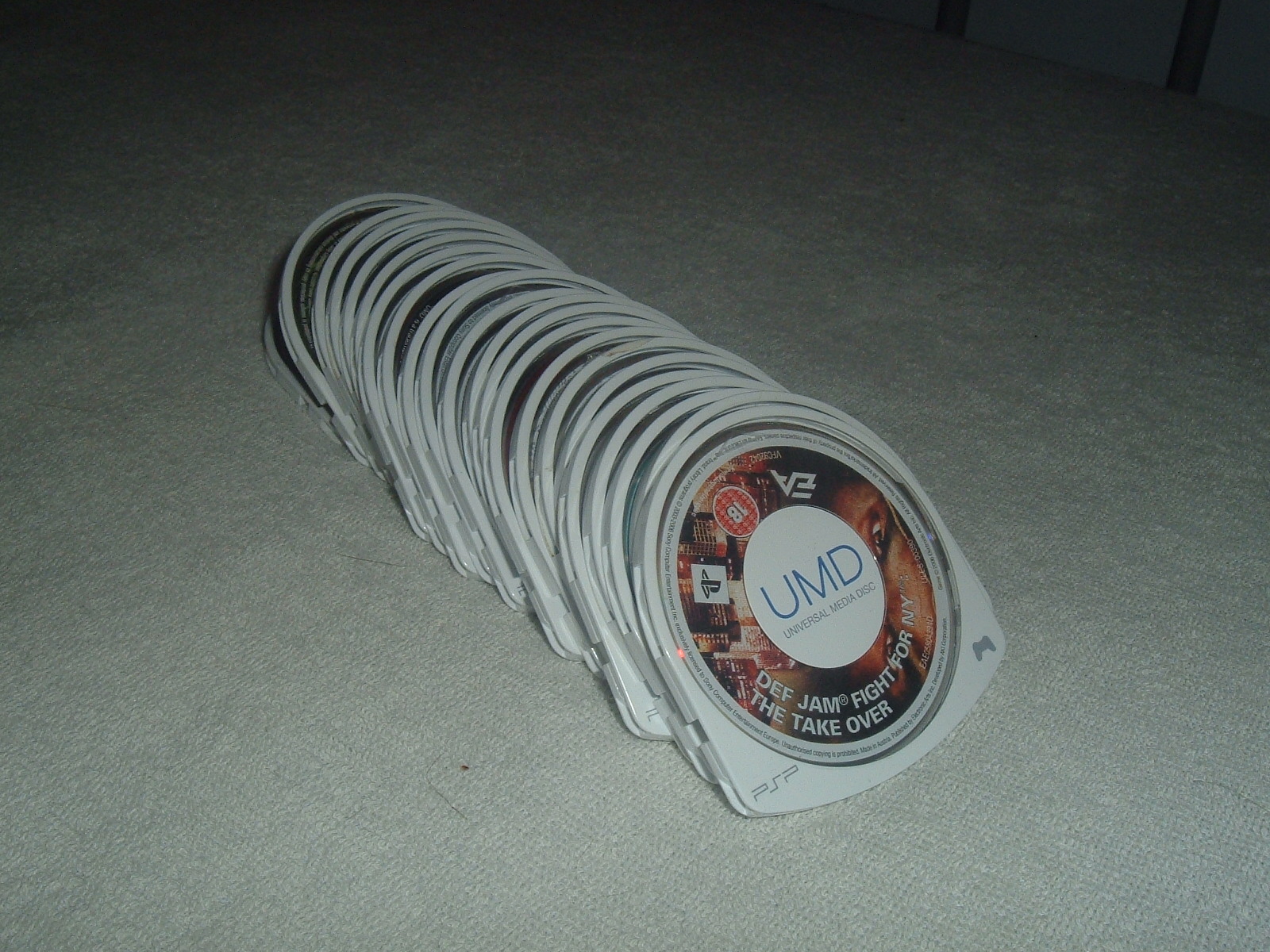 A spread of several UMDs, showing the range of game and movie titles pressed to the format at its peak