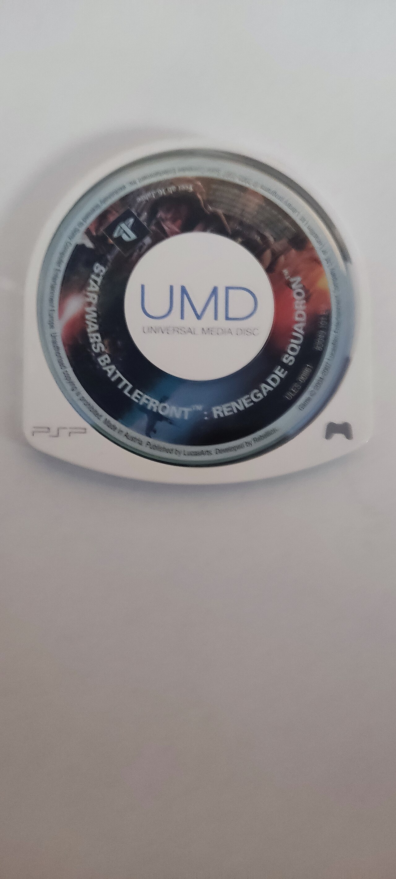 A single Universal Media Disc, the 64 mm optical disc sealed in a caddy that only the Sony PSP could read
