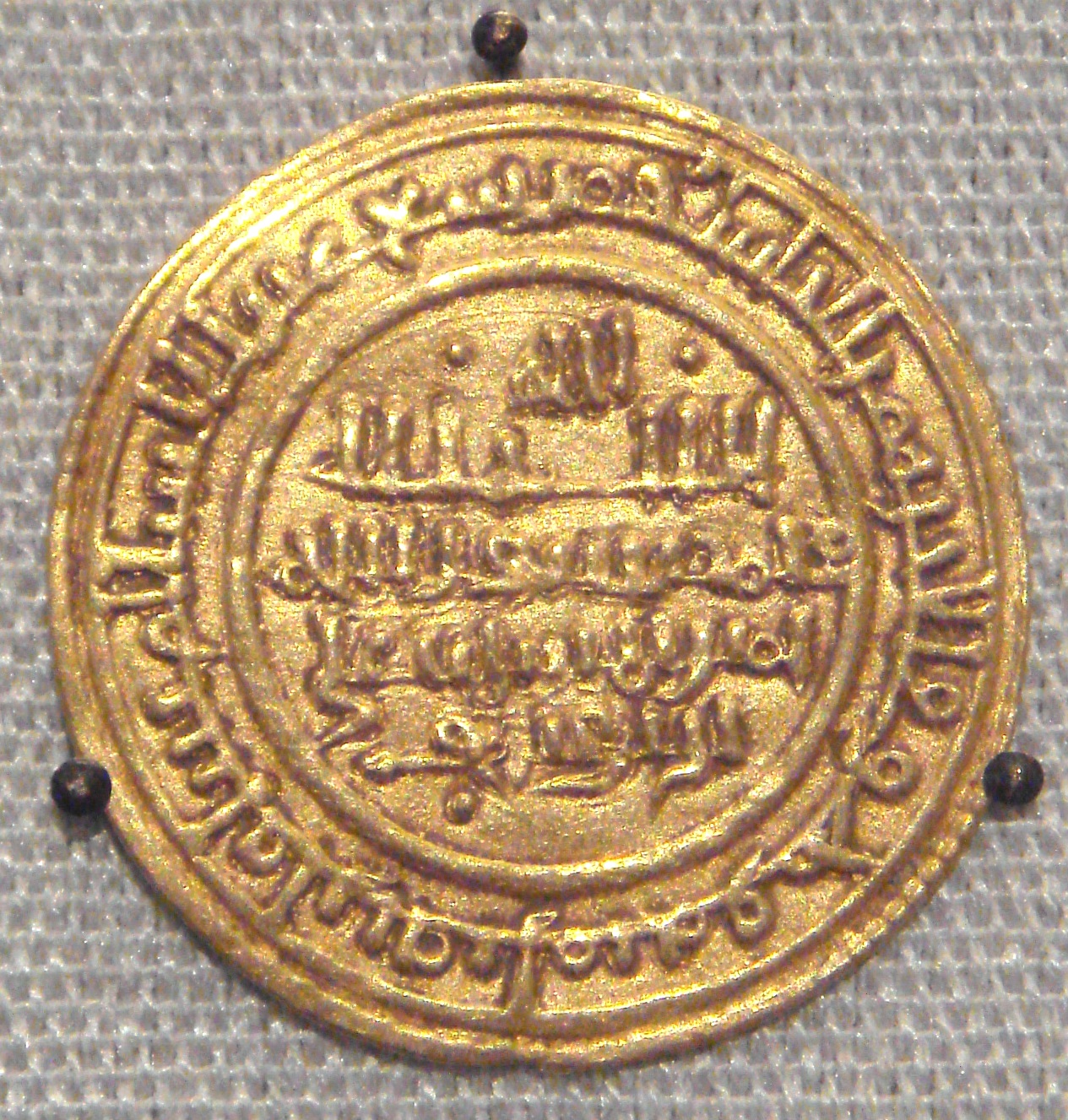 An Almoravid gold dinar struck at Seville in 1116, British Museum — the dynasty controlled the trans-Saharan gold routes and its dinars were copied in Christian Iberia as the maravedí