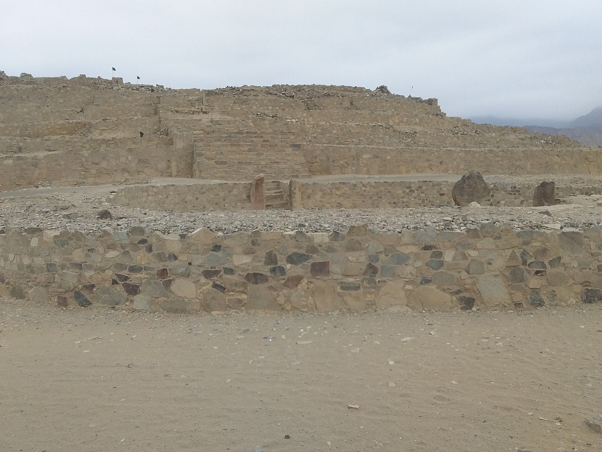 Close view of the stepped Pirámide Mayor at Caral, showing its shicra-and-stone construction and sunken circular plaza