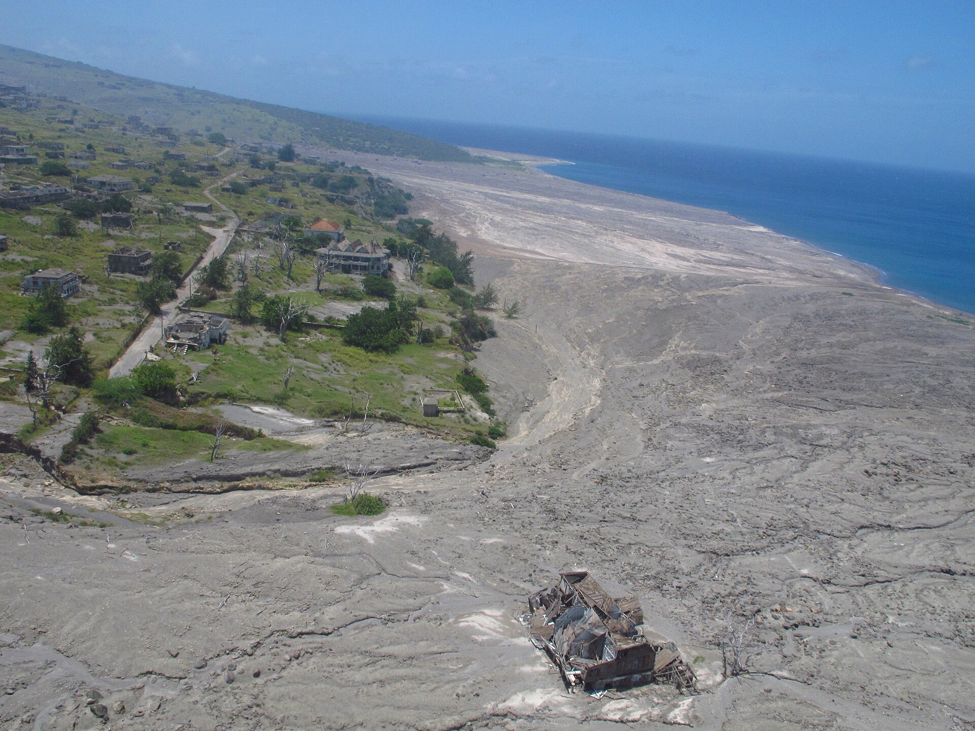 Plymouth, Montserrat from the air, its buildings buried under grey volcanic ash from Soufrière Hills.